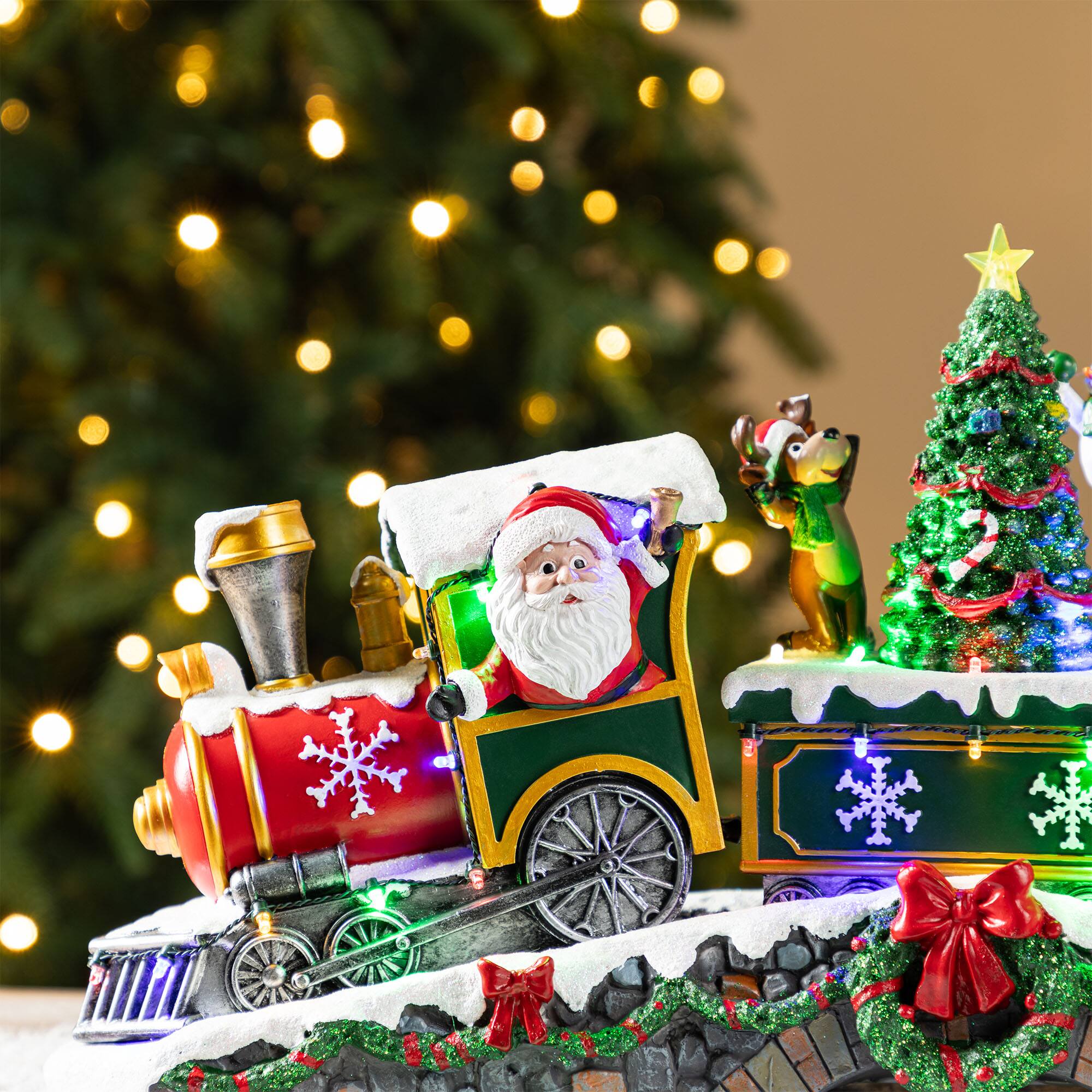 Glitzhome® 20" Lighted Christmas Santa Train Resin Village with Movement and Music